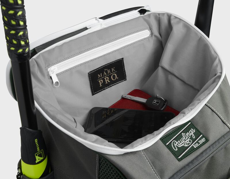 Top compartment of a dark green Impulse bag with a phone, keys and black "The Mark of a Pro" patch - SKU: IMPLSE-DG