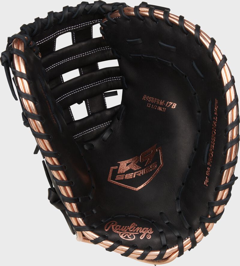Black palm of a Rawlings R9 Series fastpitch first base mitt with rose gold stamping and black laces loading=