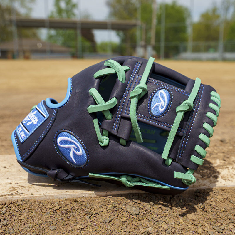 Picture of a navy exclusive Rawlings NXT Series 11.5" infield glove on a pitching rubber loading=