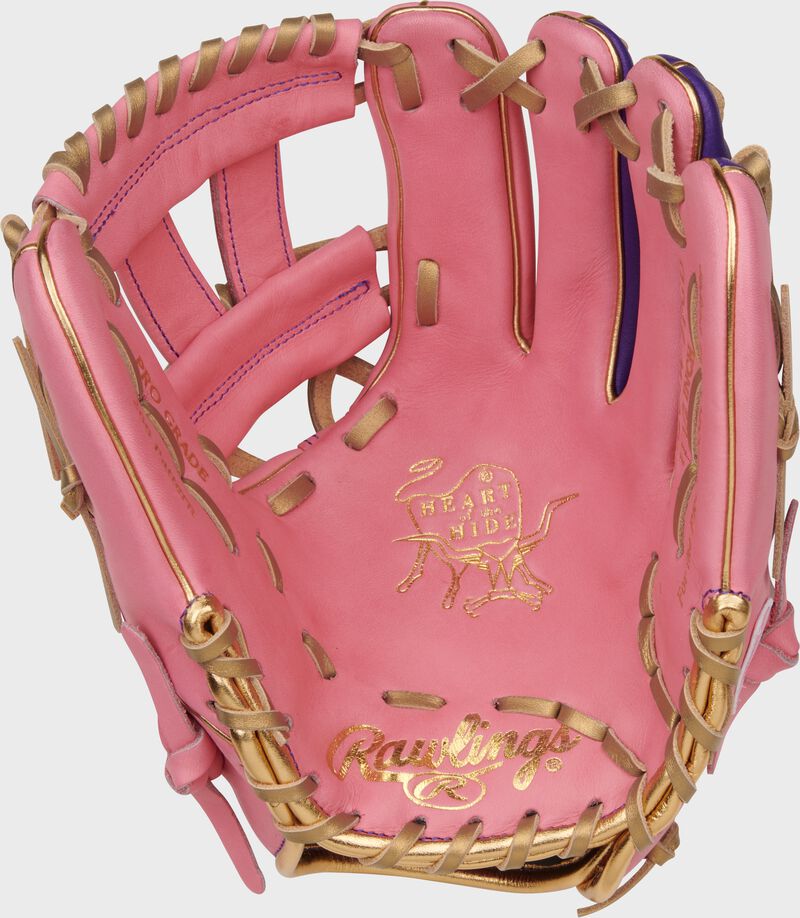 Pink palm of a Rawlings Heart of the Hide pink infield glove with gold laces and gold stamping