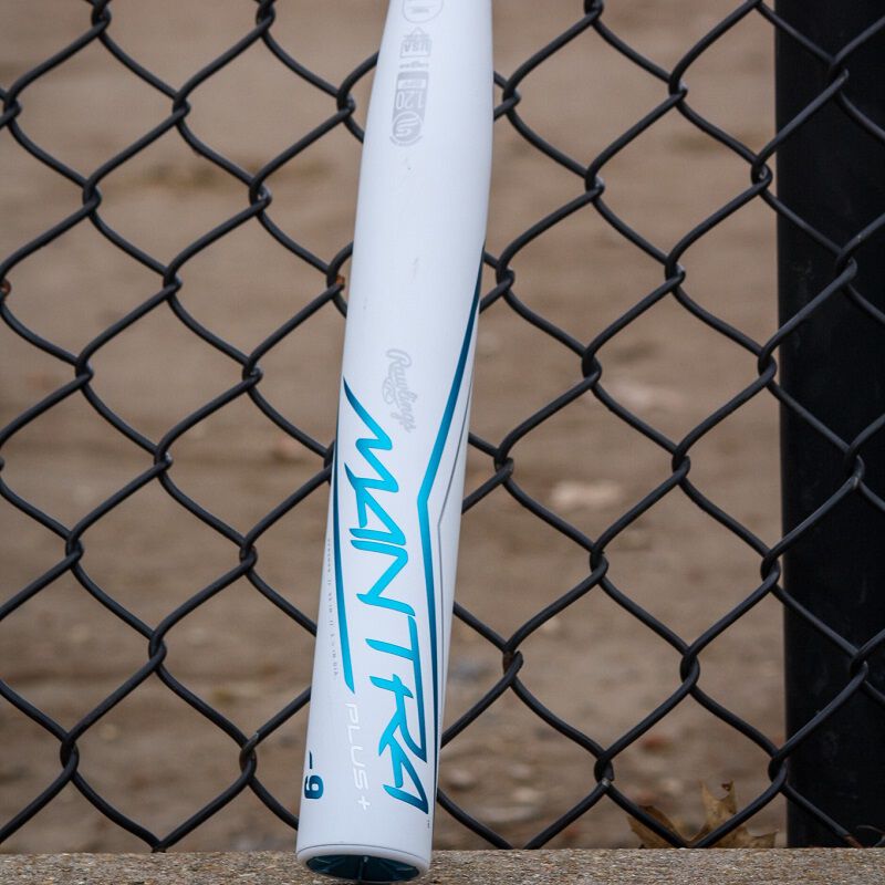 A white Rawlings Mantra+ bat leaning against a fence - SKU: RFP3MP