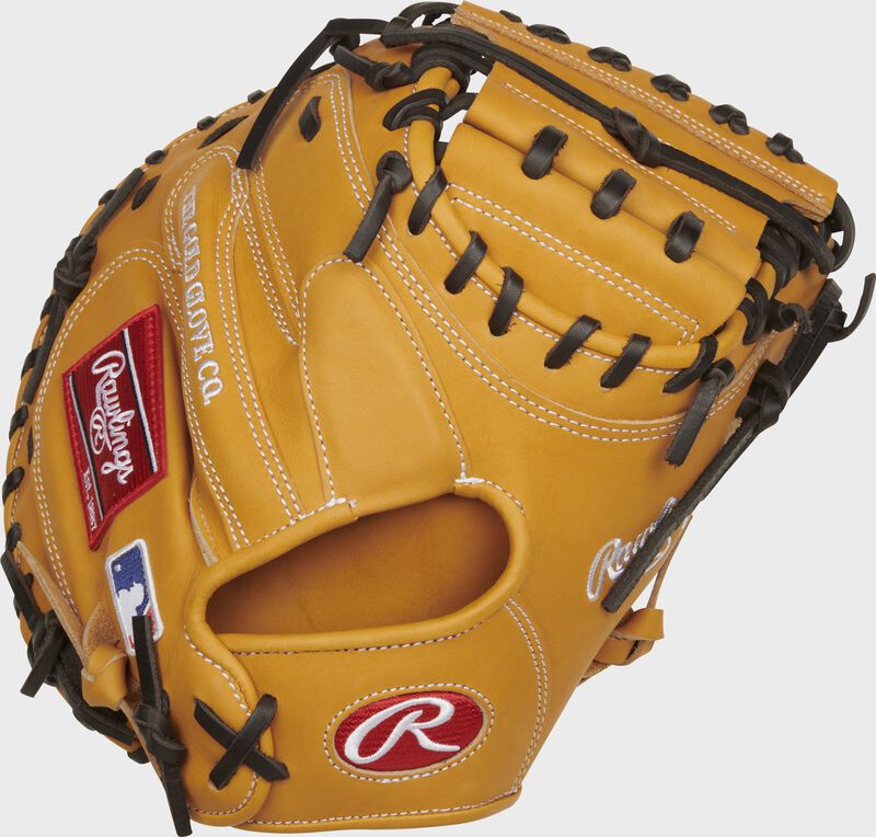 Back of a tan Heart of the Hide 33" catcher's mitt with a red Rawlings Oval-R on the wrist - SKU: PROTCM33T