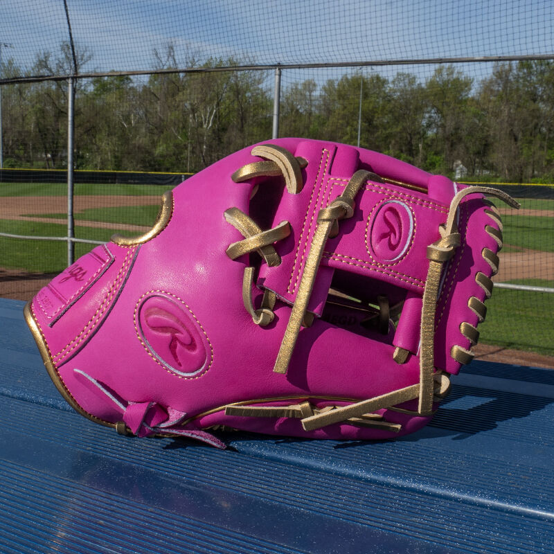 Picture of an Exclusive 11.5" R2G Heart of the Hide Berry infield glove on a bench