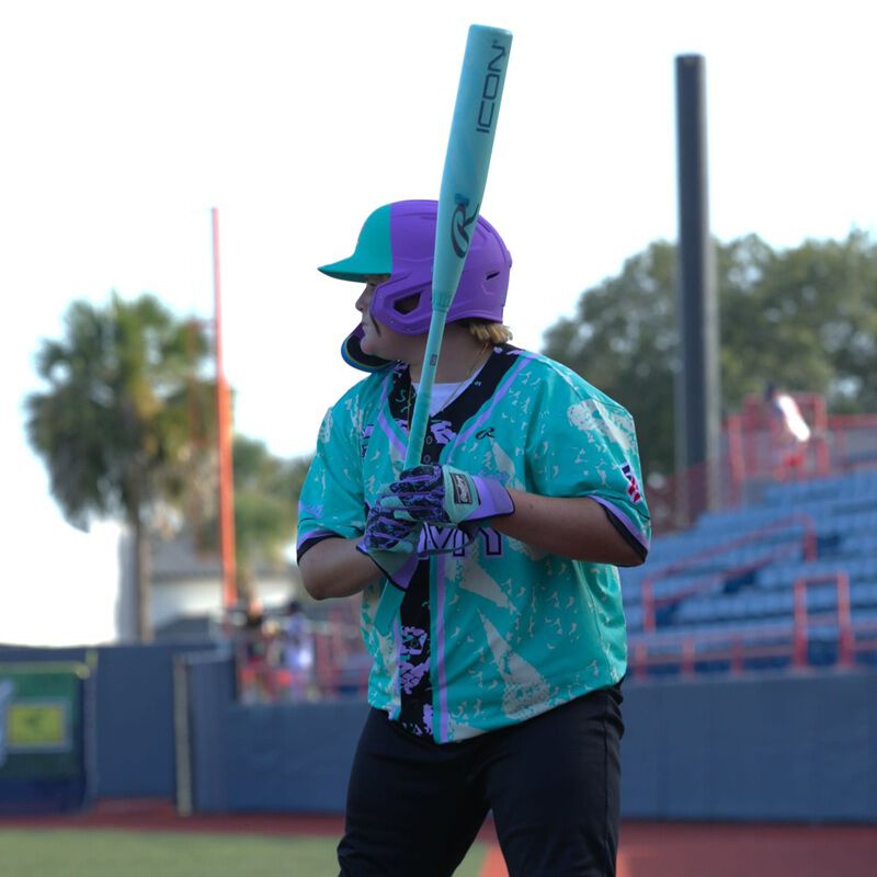 A player in the batters box with a 2026 Rawlings Icon USSSA baseball bat loading=